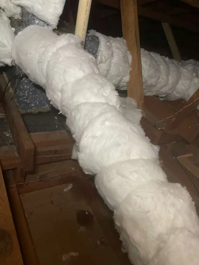 Attic insulation with spray foam for energy efficiency.