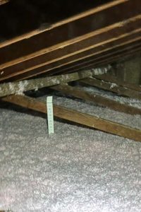 Attic insulation with foam spray for energy efficiency and temperature control.